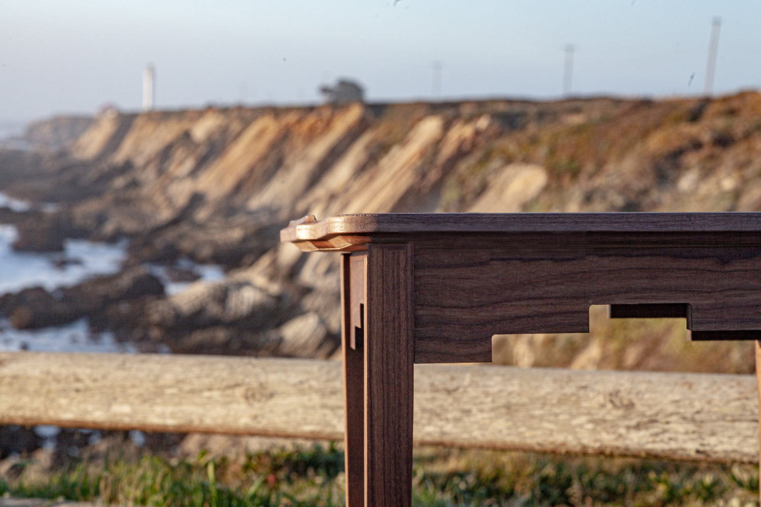 A carved walnut coffee table sits near the Point Arena Lighthouse In Mendocino County California.